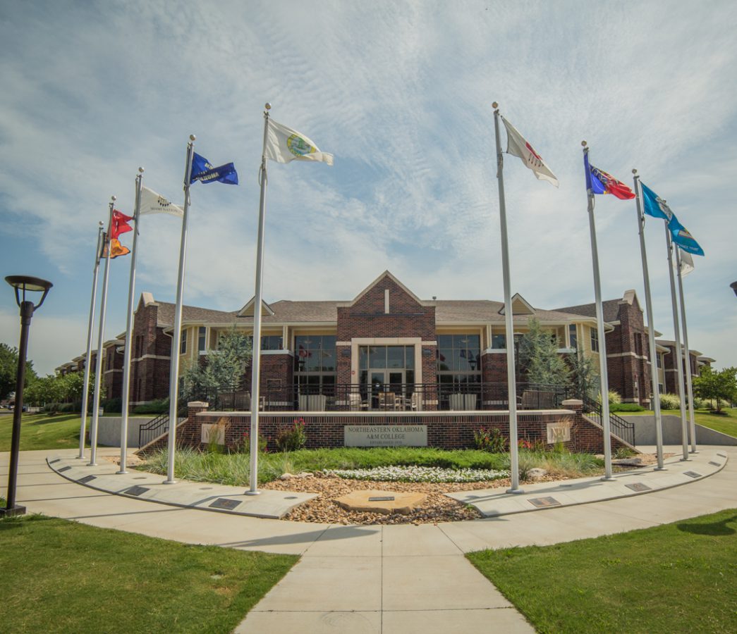 Campus building with flags in front of it