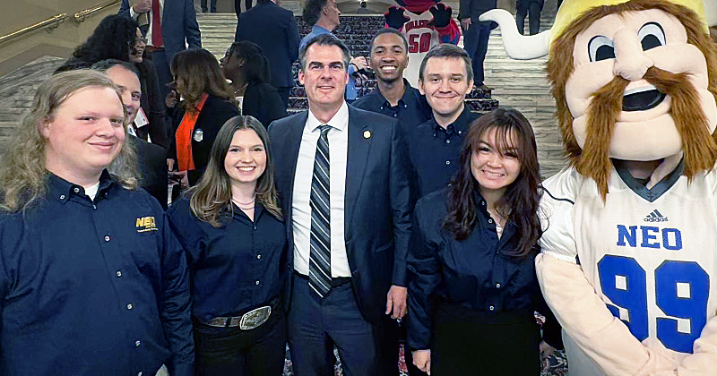 Governor Stitt poses with NEO students and mascot.